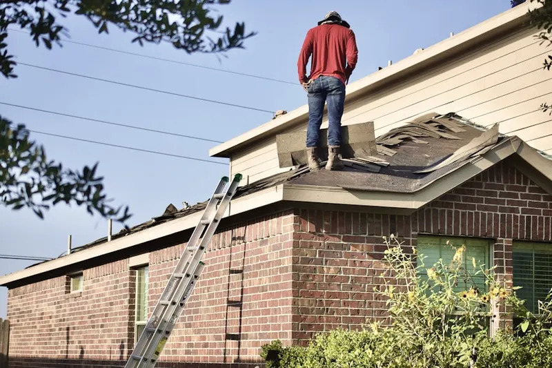 Professional roofer working on a residential roof in Olde South Estates